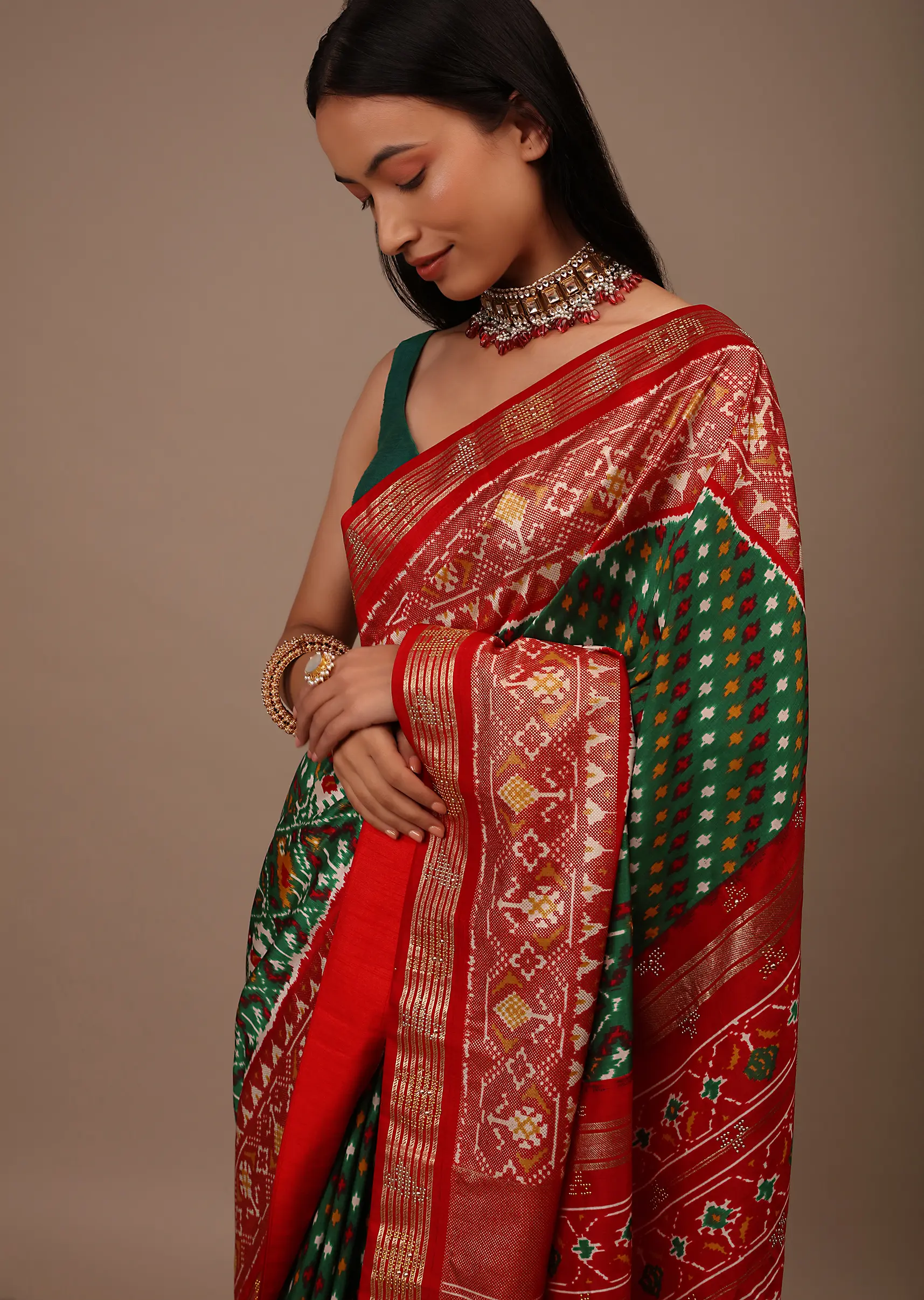Bottle Green Saree In Silk With Multi Colored Patola And Foil Print And Contrasting Red Border