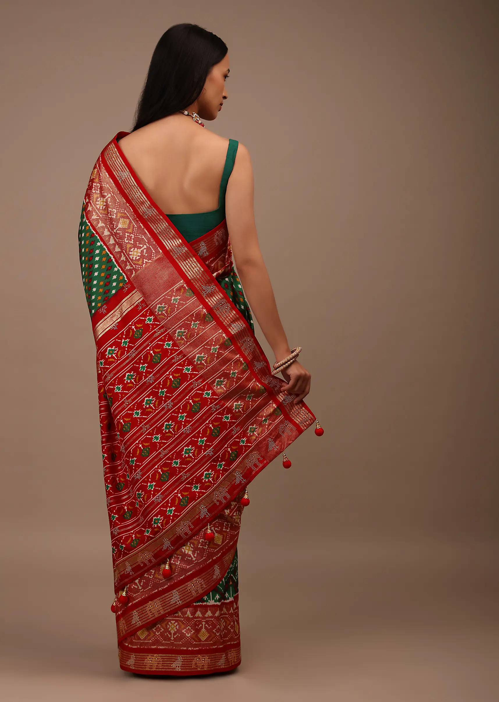 Bottle Green Saree In Silk With Multi Colored Patola And Foil Print And Contrasting Red Border